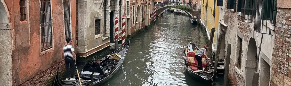 Eine Gasse in Venedig mit bunten Häusern und Booten